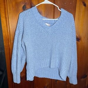 Light blue sweater with a V-neck, kind of sits off the shoulder, it’s a large